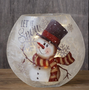 Round frosted glass luminary with a smiling snowman, red striped scarf, snowflakes, and “Let It Snow” lettering.
